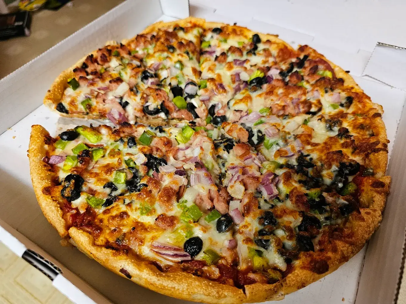 Specialty pizza with generous toppings at Firezone Edmonton